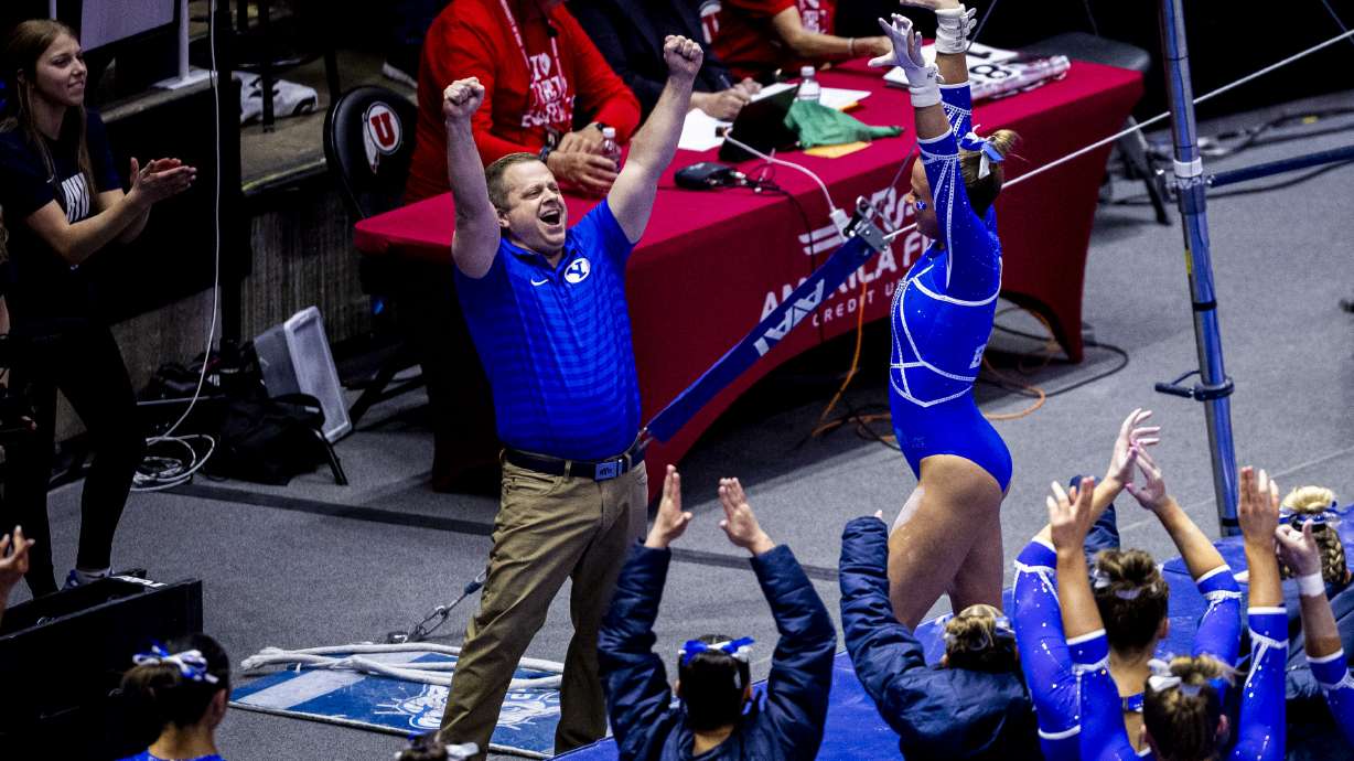 BYU gymnastics head coach Guard Young celebrates after Ava Jorgensen competed in uneven bars during an NCAA gymnastics meet against Utah held at the Huntsman Center in Salt Lake City on Friday, Feb. 13, 2026.