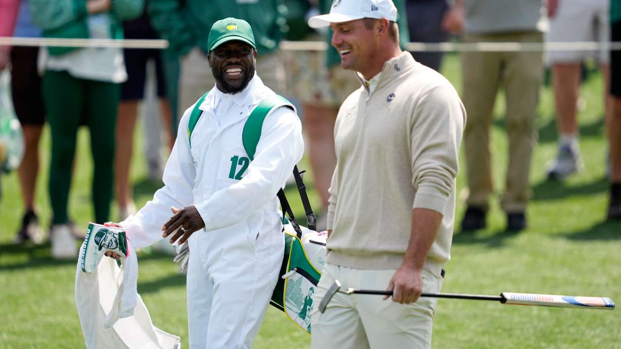 Actor Kevin Hart, left, and Bryson DeChambeau laugh during par-3 contest ahead of the Masters golf tournament at the Augusta National Golf Club, Wednesday, April 8, 2026, in Augusta, Ga.