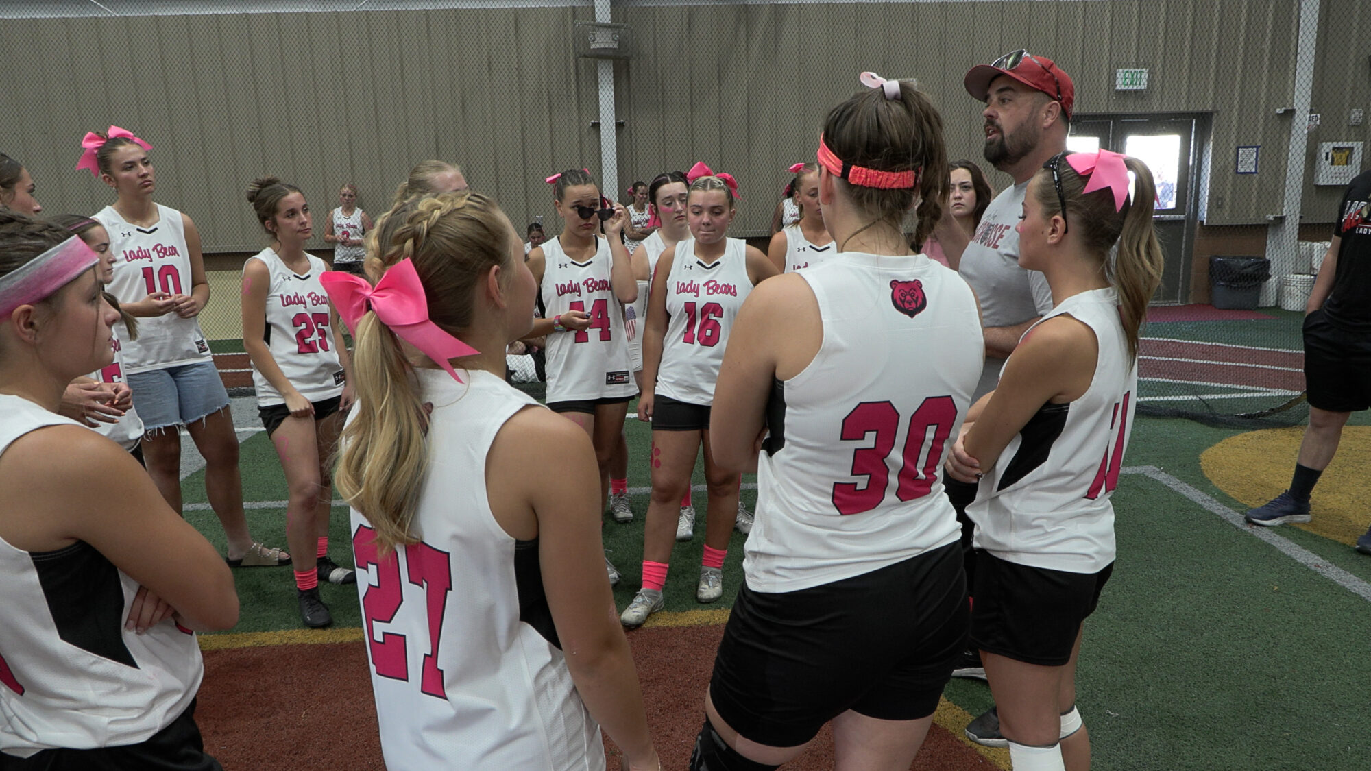 Bear River girls' lacrosse head coach Jeremy Webb speaks with his team prior to their game against Green Canyon, Wednesday. Webb began coaching the team at the invitation of his oldest daughter, despite knowing nothing about the sport.