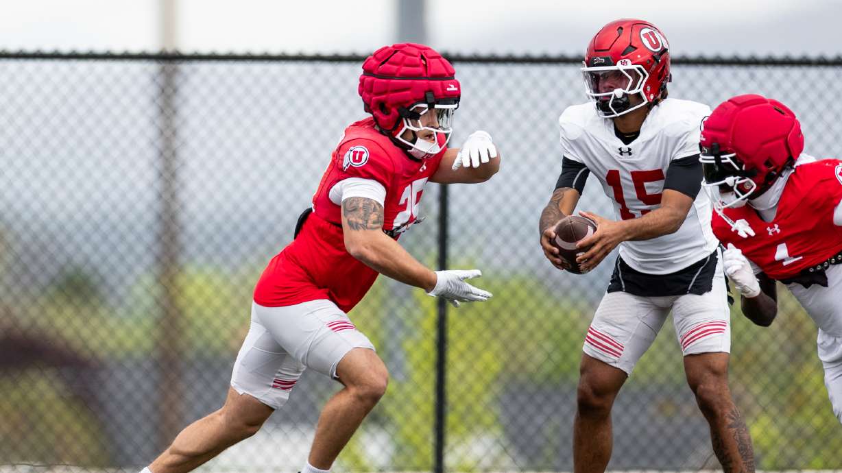 Sophomore quarterback Byrd Ficklin prepares to handoff the ball to running back Steve Chavez-Soto during spring practice in Salt Lake City.