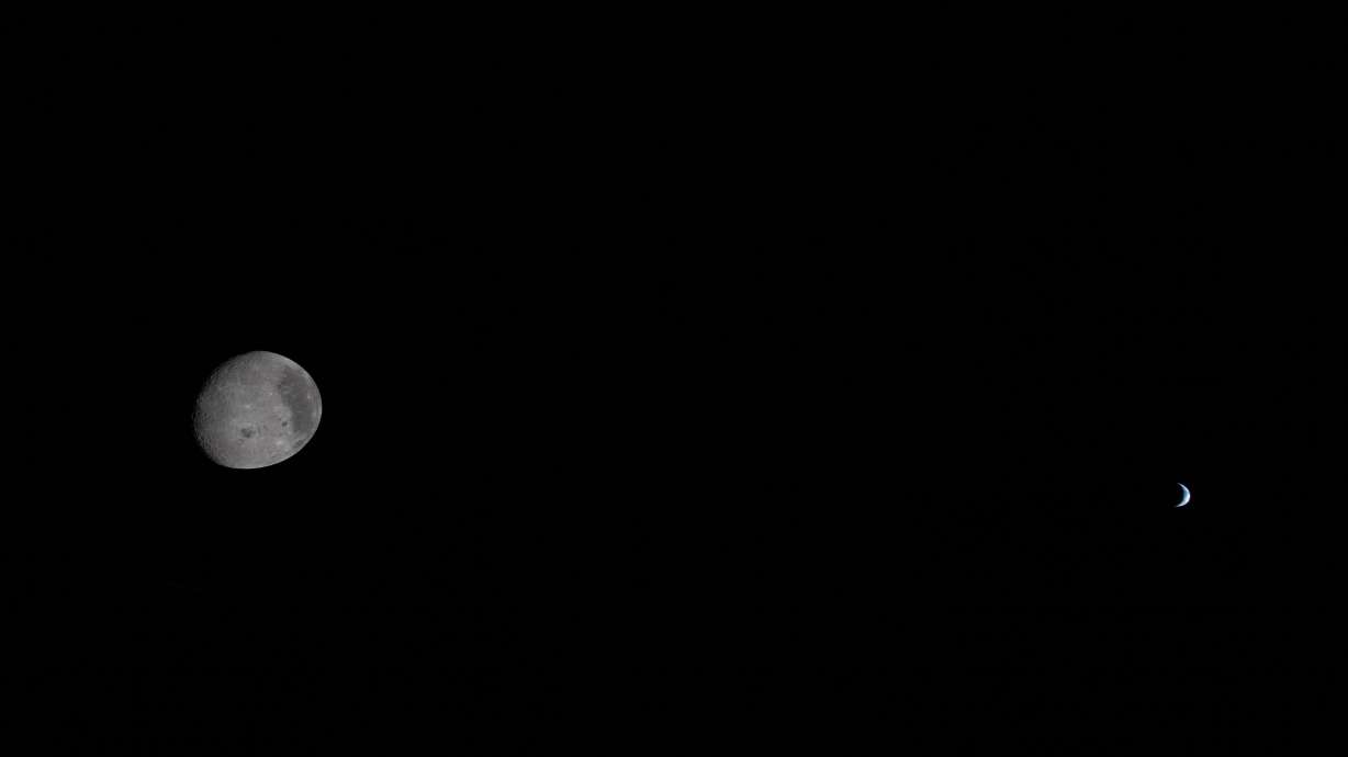In this image provided by NASA, the Artemis II crew captured this view of the moon and Earth, Monday. The crew is preparing for their "fireball" return to Earth on Friday.