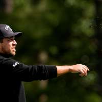 Xander Schauffele's shot lands in a viewer's merchandise bag. It didn't stop him from making par