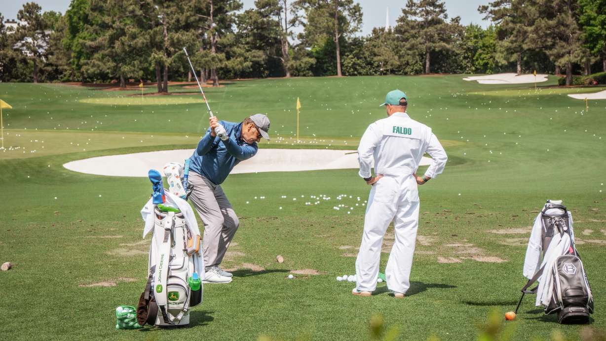 Tee Box Founder and CEO Preston Unck caddys for six-time major champion Sir Nick Faldo during the iconic Par 3 Contest at The Masters Golf Tournament.
