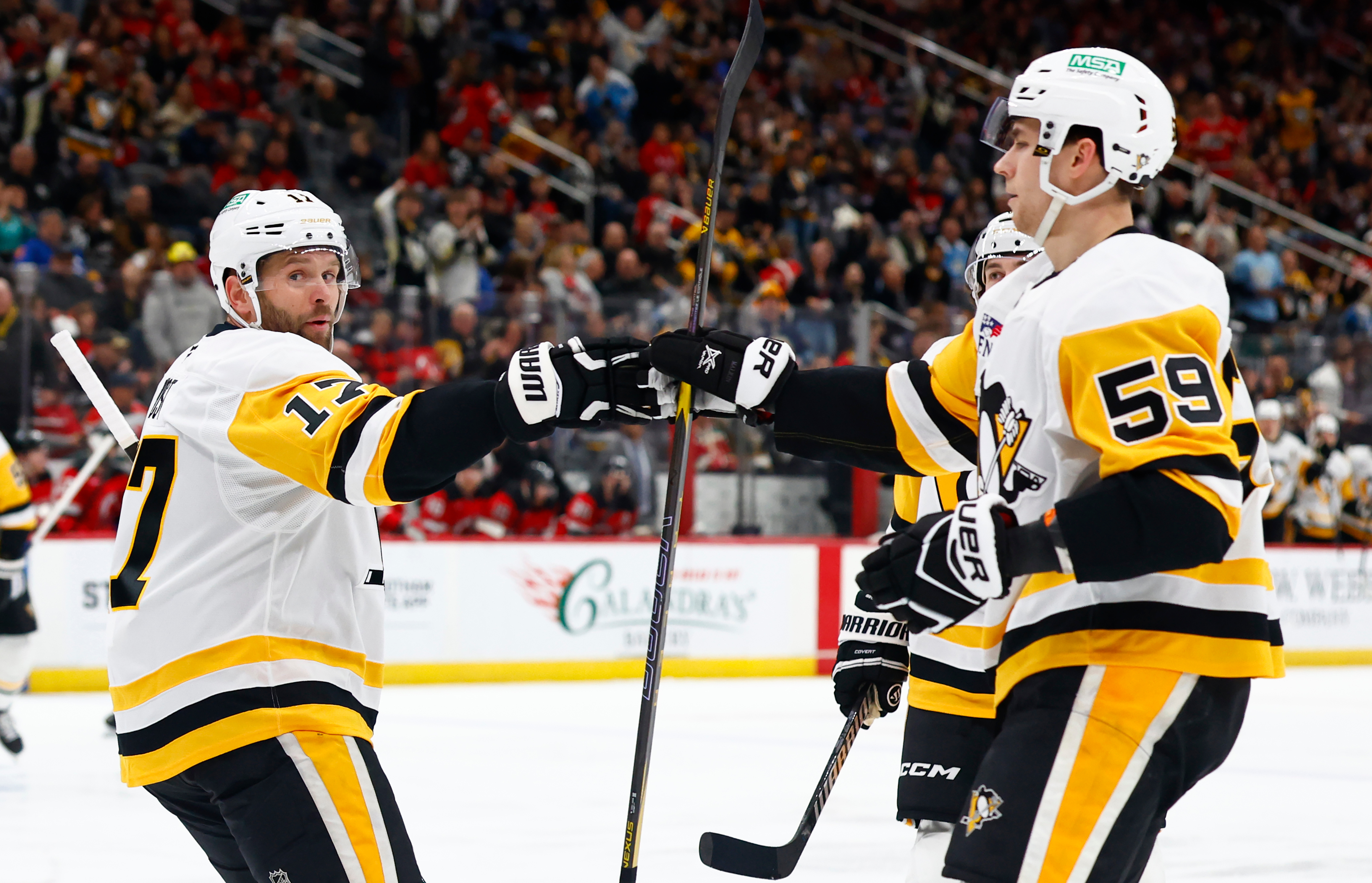 Pittsburgh Penguins right wings Bryan Rust (17) celebrates with Egor Chinakhov (59) after scoring a goal against the New Jersey Devils during the first period of an NHL hockey game, Thursday, April 9, 2026, in Newark, N.J. 