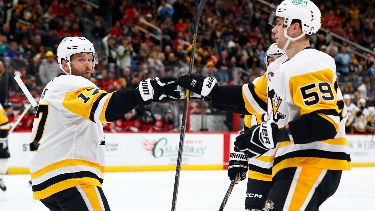 Pittsburgh Penguins right wings Bryan Rust (17) celebrates with Egor Chinakhov (59) after scoring a goal against the New Jersey Devils during the first period of an NHL hockey game, Thursday, April 9, 2026, in Newark, N.J.