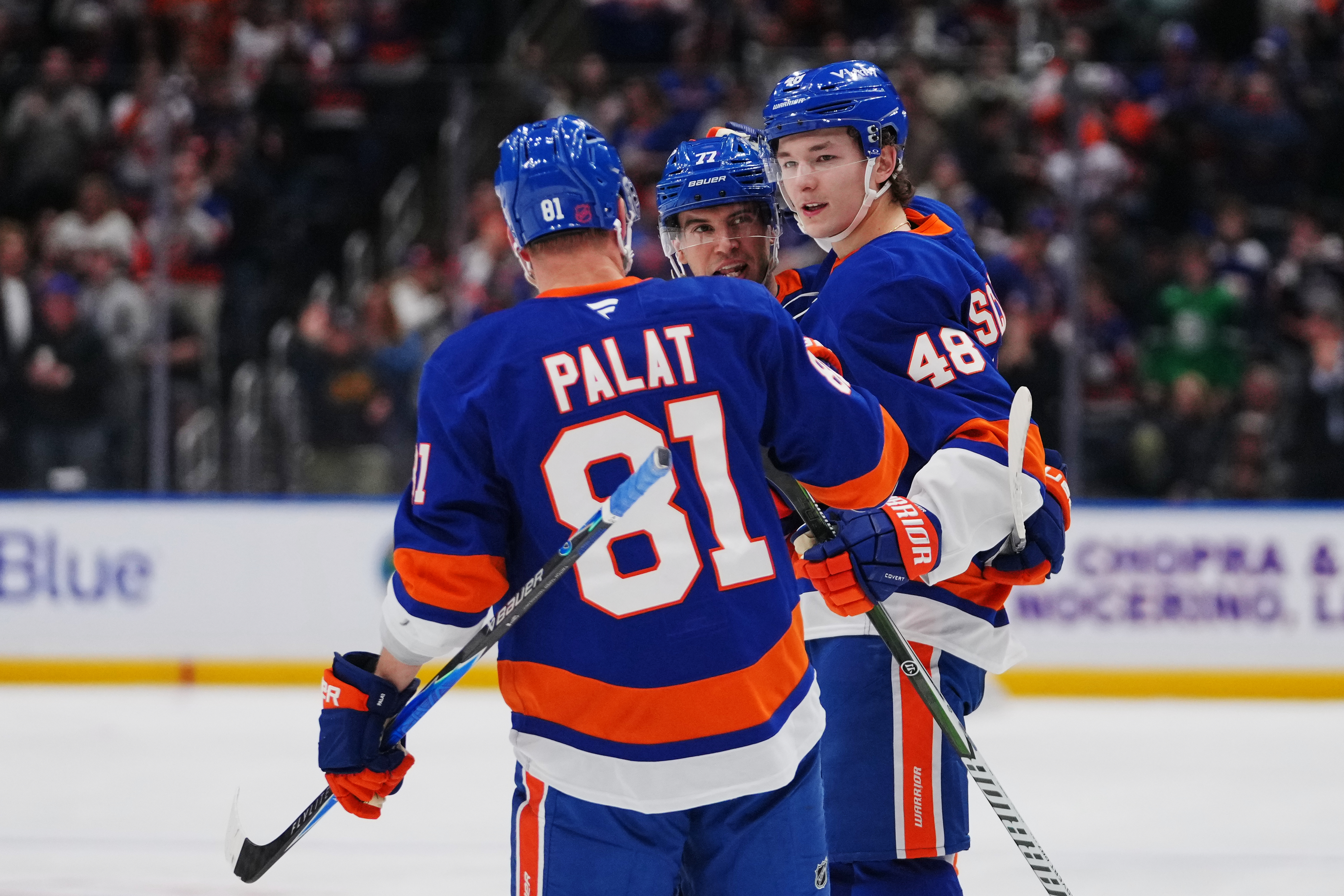 New York Islanders' Matthew Schaefer (48) celebrates with teammates Tony DeAngelo (77) andn Ondrej Palat (81) after scoring a goal during the second period of an NHL hockey game against the Toronto Maple Leafs Thursday, April 9, 2026, in Elmont, N.Y. 