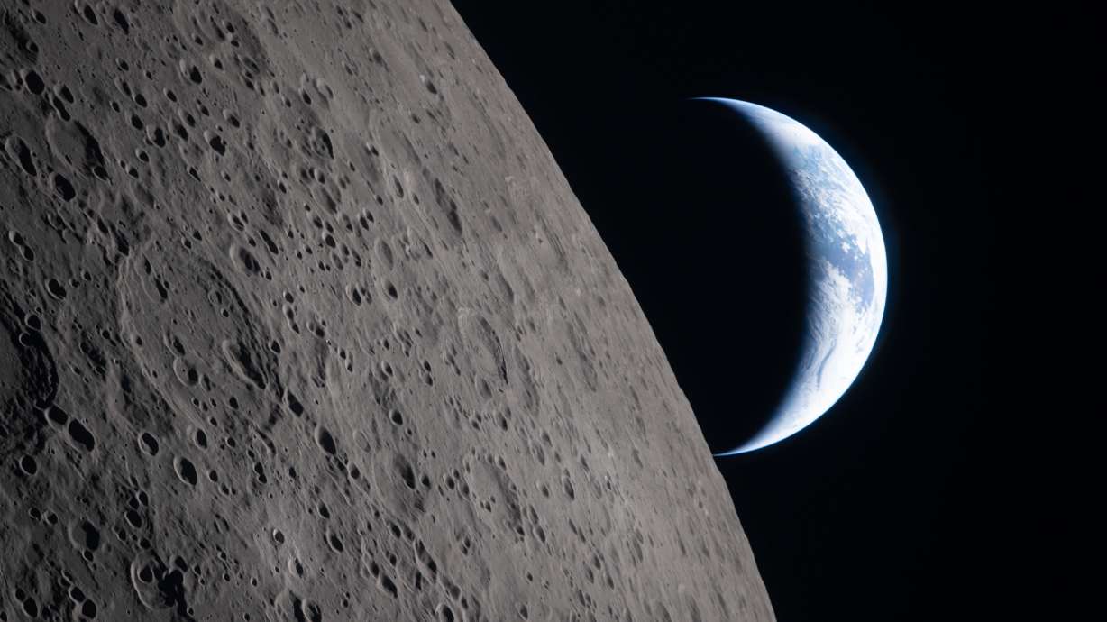 In this image provided by NASA, the Artemis II crew captured this view as the Earth sets behind the Moon during a lunar flyby, Monday. The crew aimed for a splashdown in the Pacific on Friday.