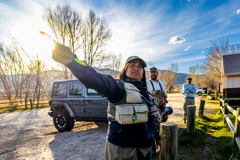 From left, Rebeca Granillo, a fly-fishing instructor from Millcreek, points out areas to fish along the Provo River to A.J. Neste, of Flagler, Fla., and Tyler James, of Williamsburg, Va., at a trailhead near Charleston on Wednesday.