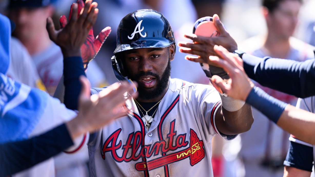 Atlanta Braves' Michael Harris II is greeted by teammates after scoring during the sixth inning of a baseball game against the Los Angeles Angels, Wednesday, April 8, 2026, in Anaheim, Calif.