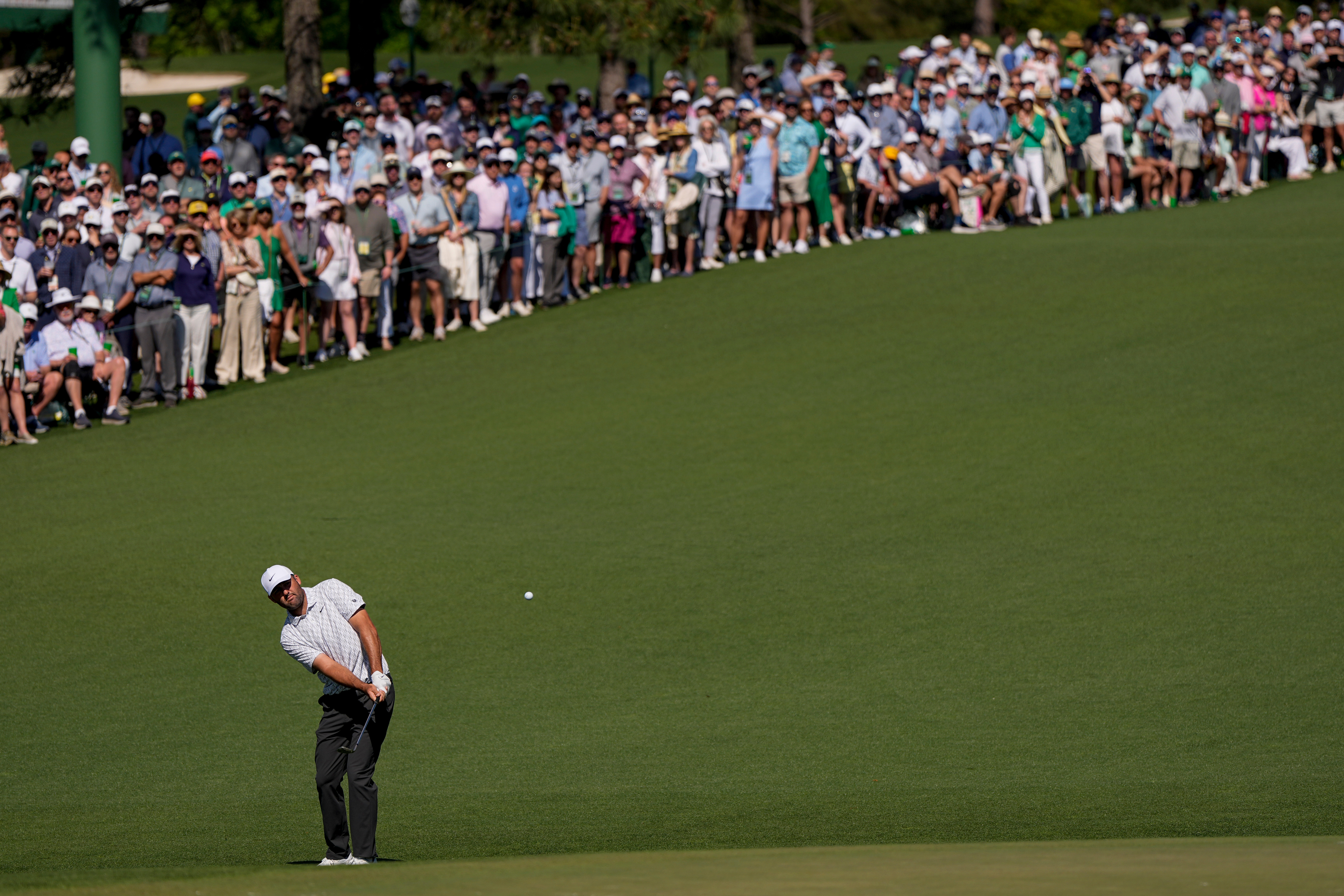 Scottie Scheffler chips to the green on the second hole during the second round of the Masters golf tournament at the Augusta National Golf Club, Friday, April 10, 2026, in Augusta, Ga. 