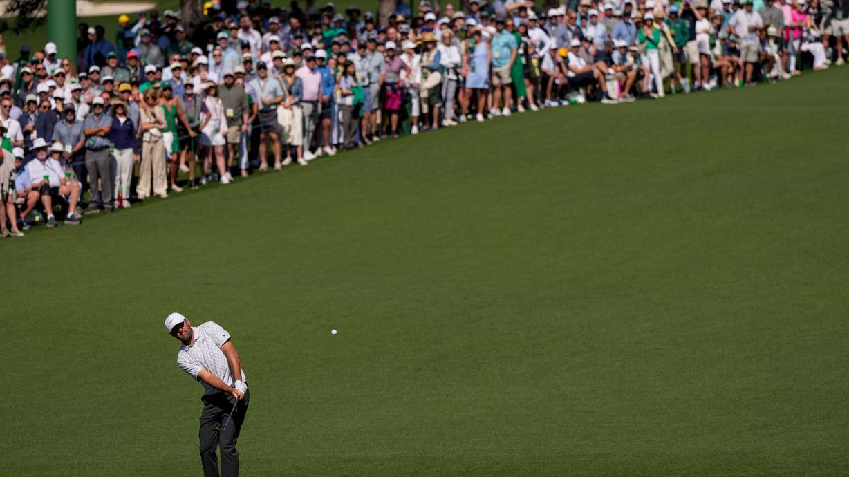 Scottie Scheffler chips to the green on the second hole during the second round of the Masters golf tournament at the Augusta National Golf Club, Friday, April 10, 2026, in Augusta, Ga.