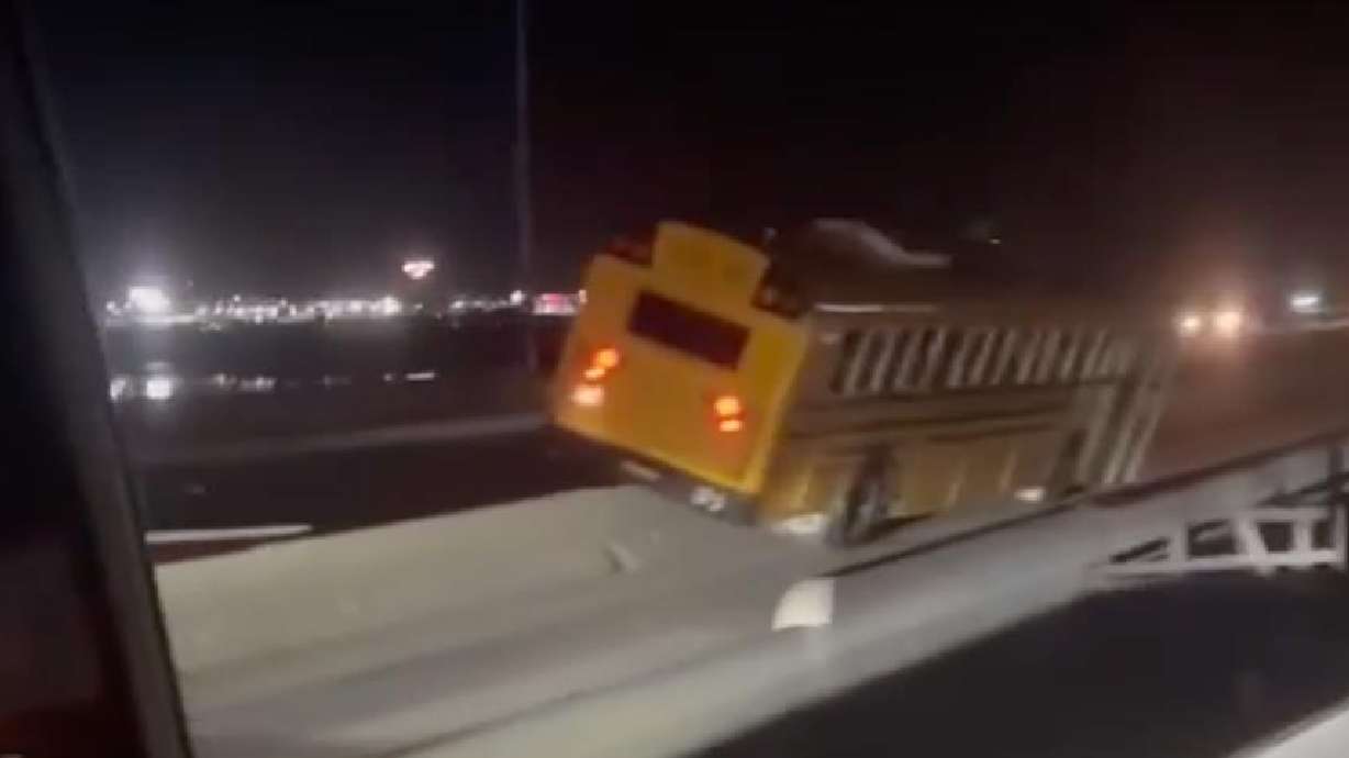 An Idaho school bus on Interstate 84 near Heyburn after a hit-and-run, Thursday. The bus struck a concrete barrier after being hit by a driver, Idaho State Police said.