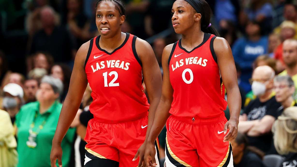 FILE - Las Vegas Aces guard Chelsea Gray (12) and guard Jackie Young (0) look on during the second half of Game 4 of a WNBA basketball playoff semifinal against the Seattle Storm, Tuesday, Sept. 6, 2022, in Seattle.