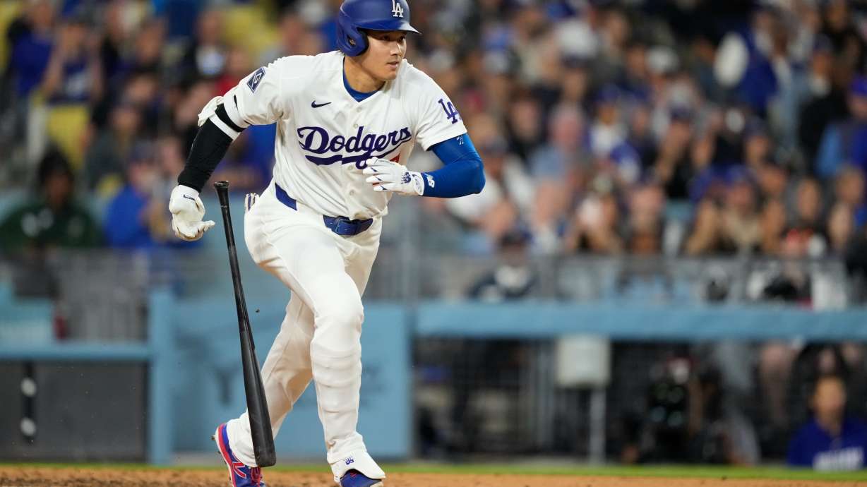 Los Angeles Dodgers' Shohei Ohtani heads to first for a single during the fifth inning of a baseball game against the Texas Rangers, Friday, April 10, 2026, in Los Angeles.