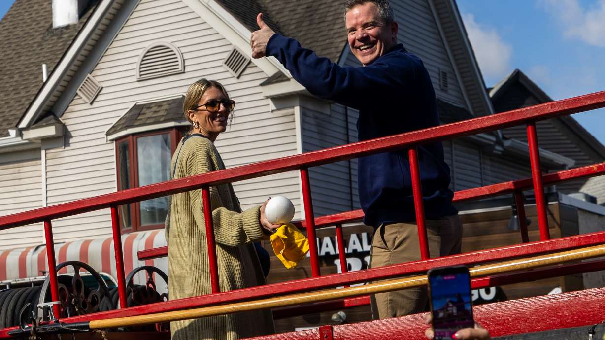 Michigan head coach Dusty May gestures during a parade celebrating their national championship win in the NCAA college basketball tournament , Saturday, April 11, 2026, in Ann Arbor, Mich.
