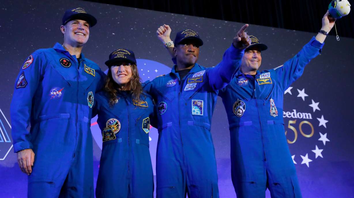 The Artemis II crew, from left, Jeremy Hansen, Christina Koch, Victor Glover and Reid Wiseman come to the center stage at the end of a crew return event, Saturday, at Ellington Field in Houston. The astronauts received a huge welcome following their record-breaking trip to the moon.