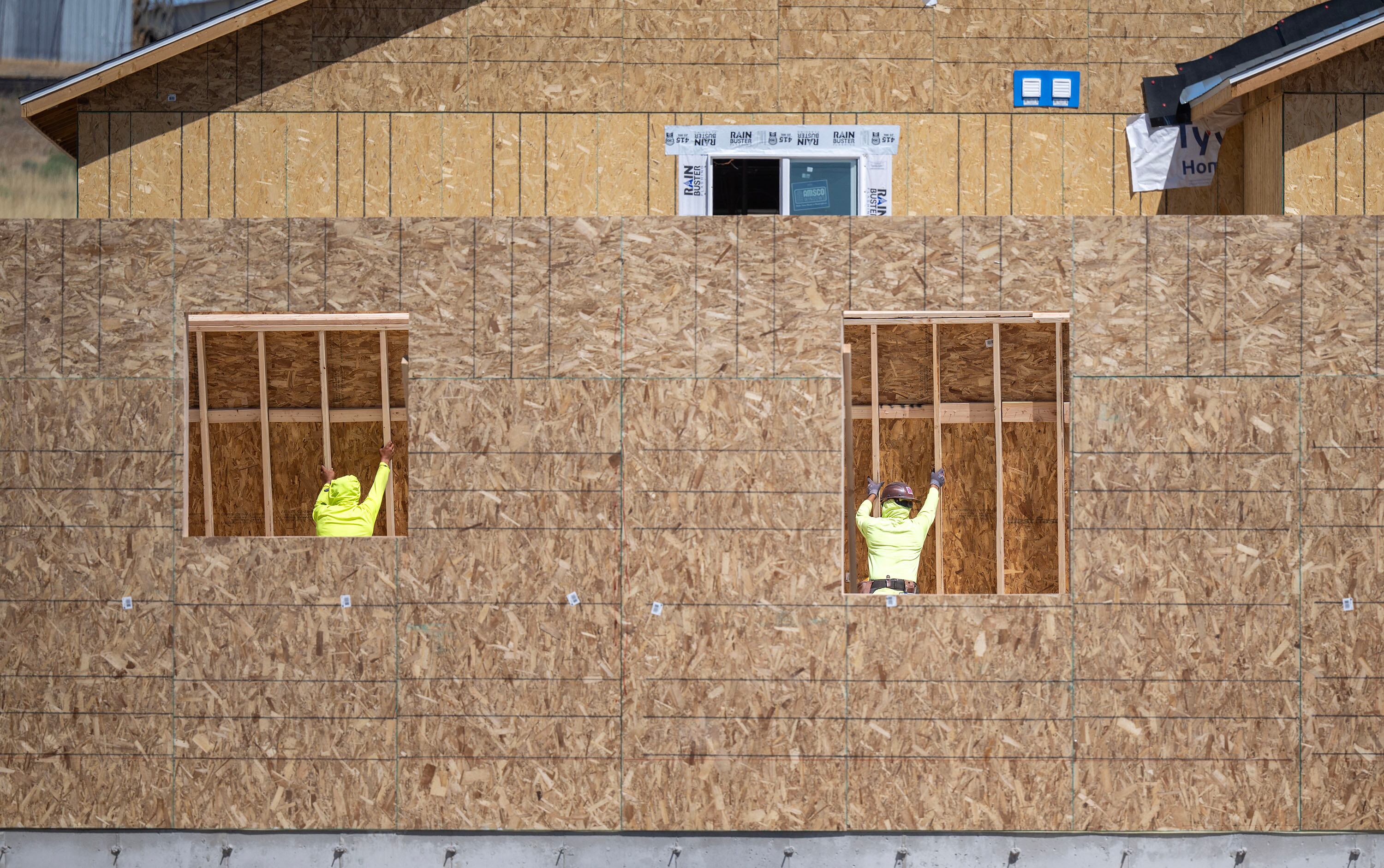 Workers lift a wall into place as they build a home in West Jordan on Aug. 11. Construction jobs are popular summer jobs for Utah teenagers.
