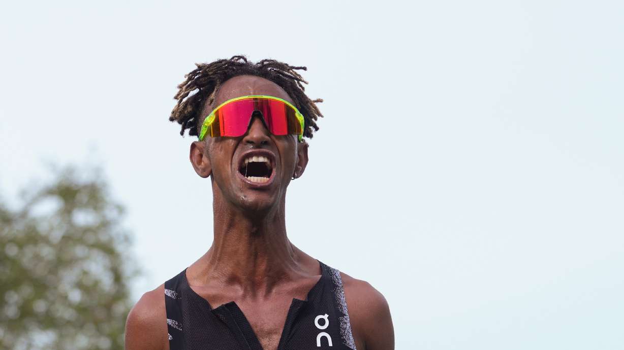 Italy's Yemaneberhan Crippa celebrates after crossing the finish line to win the men's race of the Paris marathon, in Paris, Sunday, April 12, 2026.