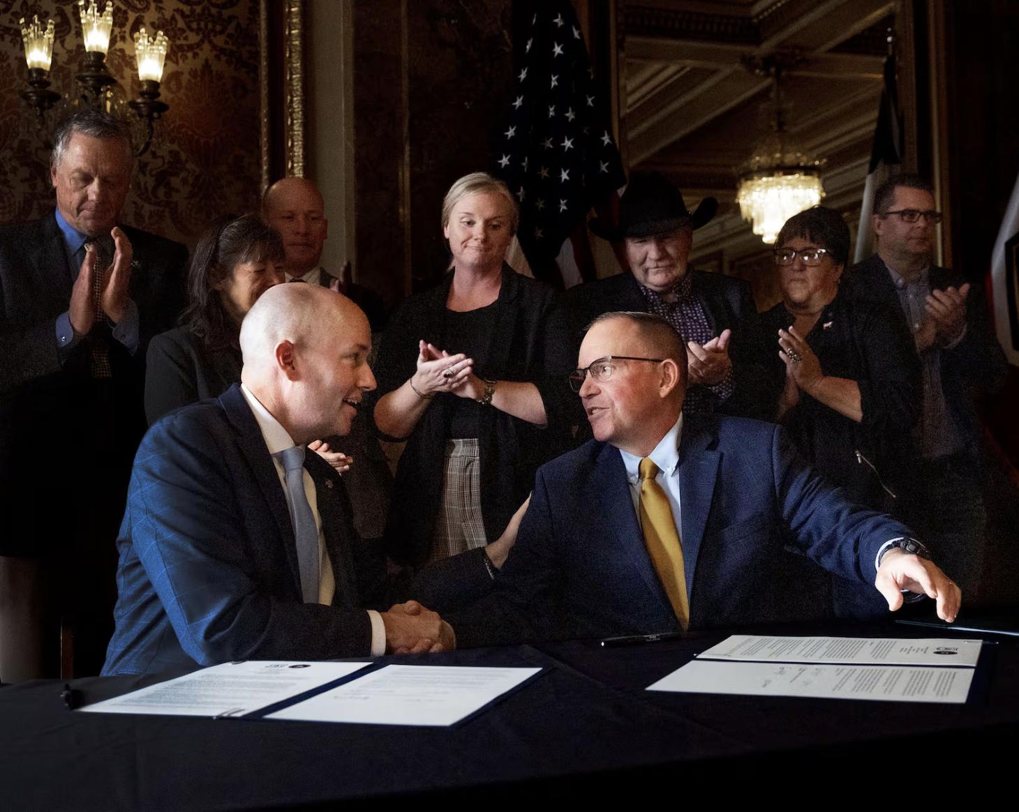 Gov. Spencer Cox and Tom Schultz, chief of the U.S. Department of Agriculture Forest Service, sign a cooperative agreement between the state of Utah and the United States Department of Agriculture Forest Service at the Capitol in Salt Lake City on Jan. 8.