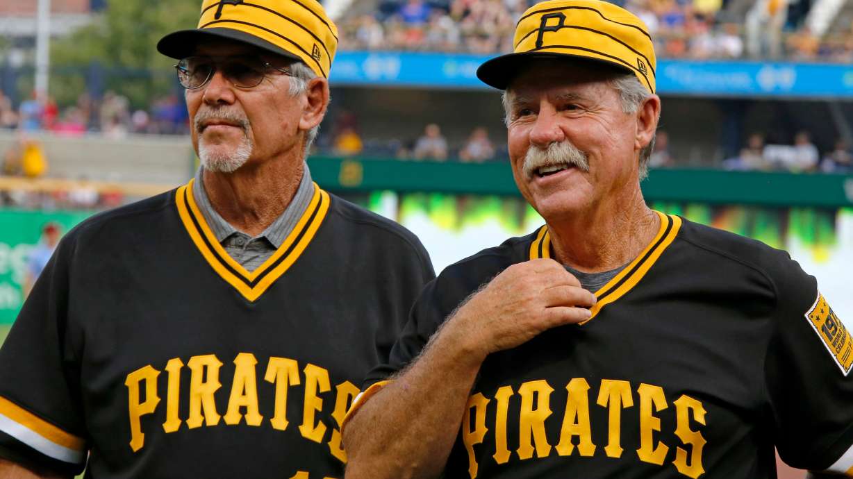 FILE - Tim Foli, left, and Phil Garner, the middle infield of the 1979 World Championship Pittsburgh Pirates team attend a pre-game ceremony remembering the team's accomplishment 40 years ago before a baseball game between the Pittsburgh Pirates and the Philadelphia Phillies in Pittsburgh, July 20, 2019.