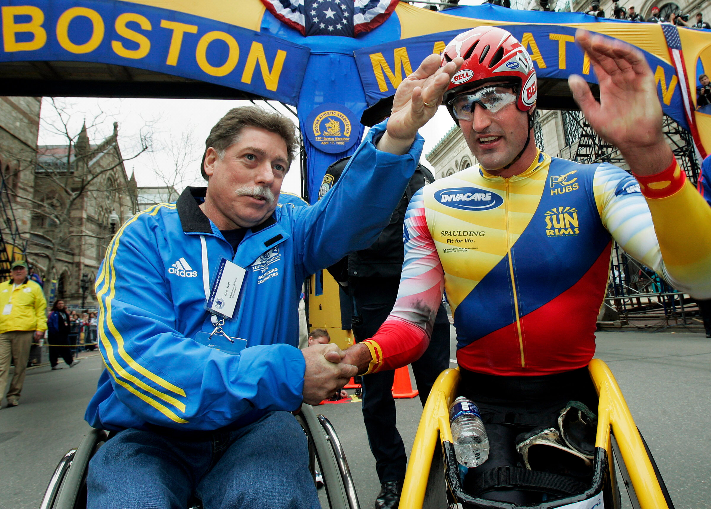 FILE - Ernst Van Dyk of South Africa, right, shakes hands with former wheelchair winner Bob Hall, after he won the mens wheelchair division of the 110th running of the Boston Marathon, Monday, April 17, 2006.