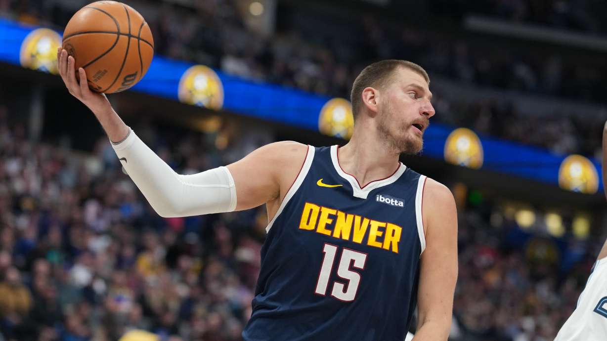 Denver Nuggets center Nikola Jokić pulls in a loose ball in the first half of an NBA basketball game against the Memphis Grizzlies Wednesday, April 8, 2026, in Denver.