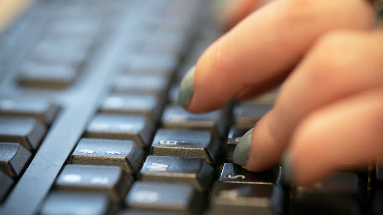 A person types on a computer keyboard in New York, Oct. 8, 2019.