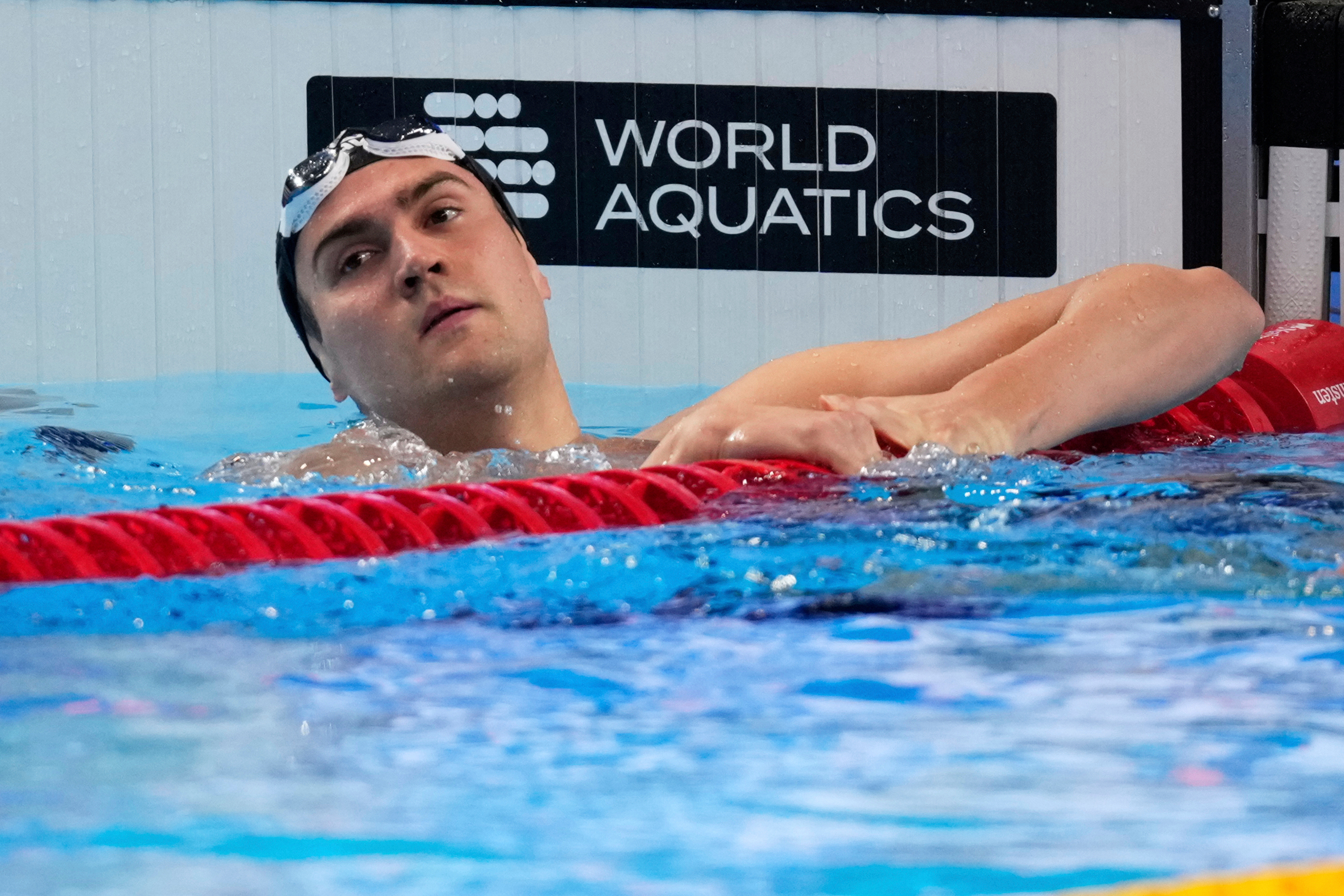FILE - Neutral Athlete Russia, Kliment Kolesnikov reacts after winning gold medal in the men's 50-meter backstroke final at the World Aquatics Championships in Singapore, on Aug. 3, 2025.