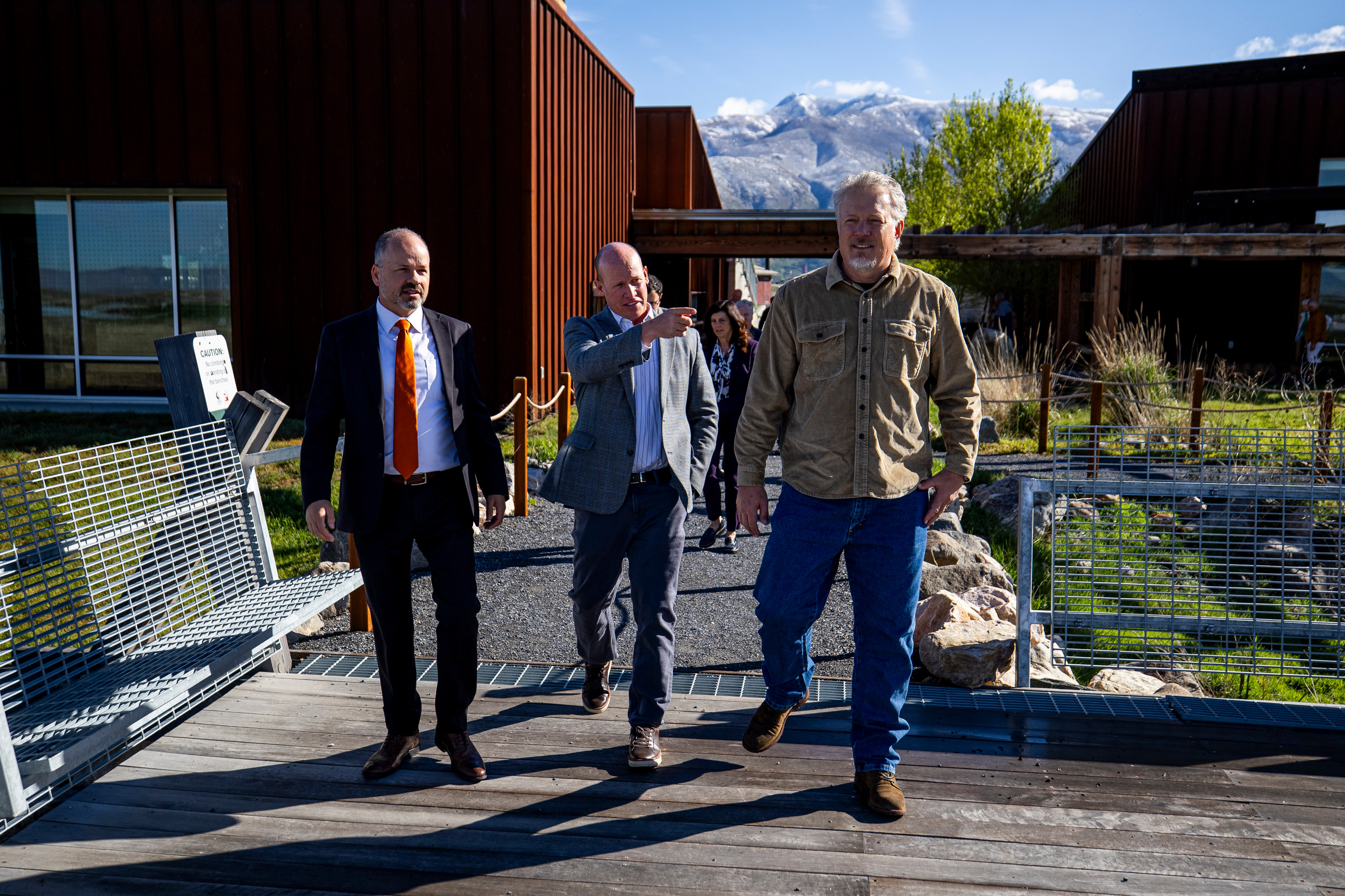 Joel Ferry points toward the Great Salt Lake as he walks with Timothy Hawkes and Greg Miller to the observation deck at the Eccles Wildlife Education Center in Farmington on Monday.