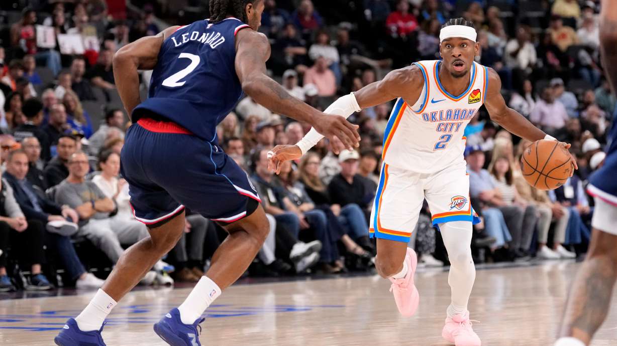 Oklahoma City Thunder guard Shai Gilgeous-Alexander, right, tries to get past Los Angeles Clippers forward Kawhi Leonard during the first half of an NBA basketball game Wednesday, April 8, 2026, in Inglewood, Calif.