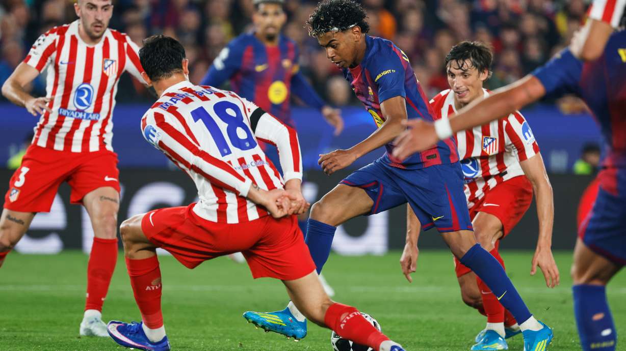 Barcelona's Lamine Yamal challenges for the ball with Atletico Madrid's Marc Pubill during the Champions League quarterfinal first leg soccer match between Barcelona and Atletico Madrid in Barcelona, Spain, Wednesday, April 8, 2026.