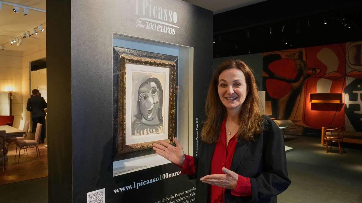 Peri Cochin next to "Head of a Woman" by Pablo Picasso, in Paris, Friday, ahead of a lottery in which the painting is being raffled off to raise money for Alzheimer’s research. An art enthusiast won a $1 million Picasso with a $117 ticket on Wednesday.