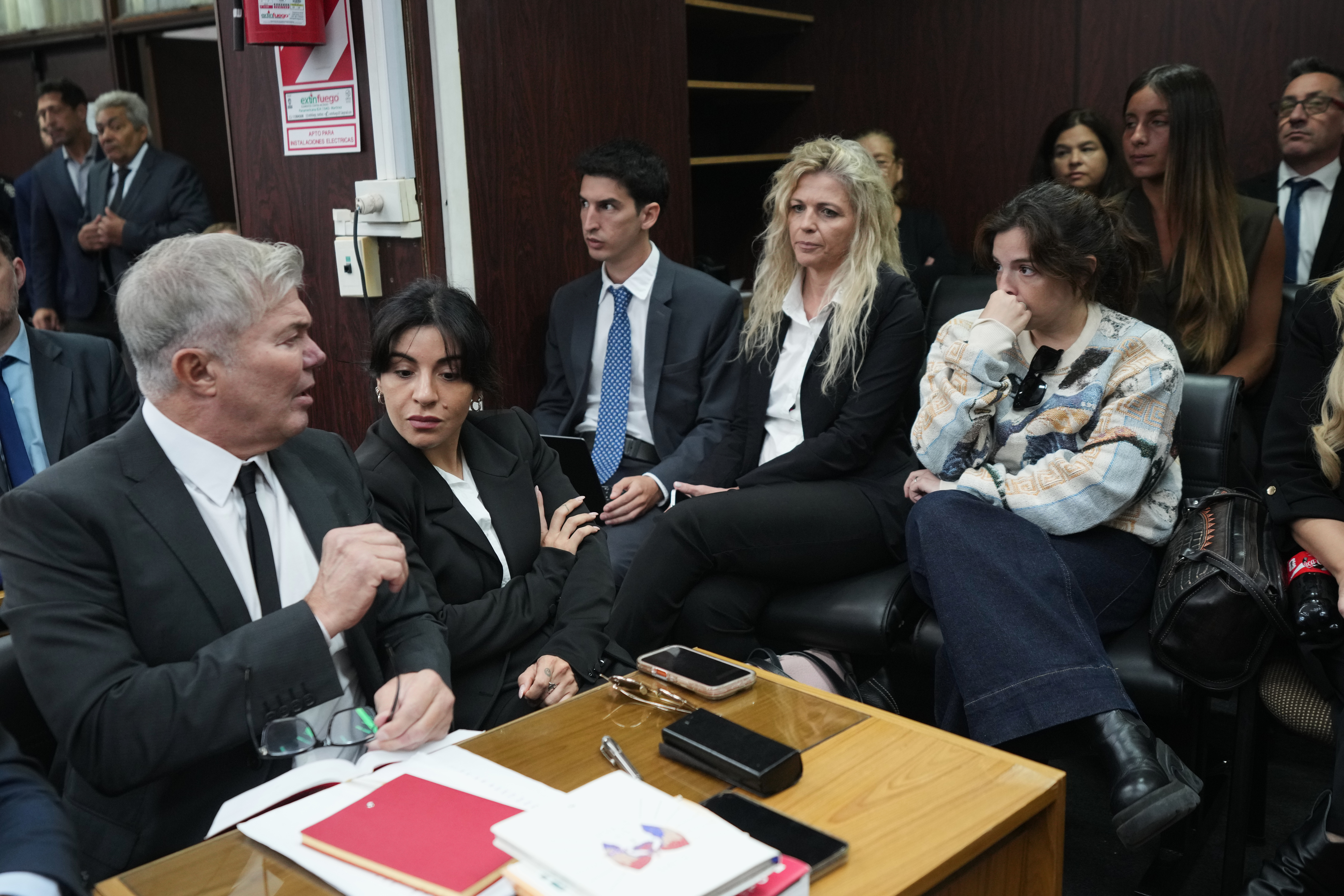 Dalma Maradona, right, and Gianinna Maradona, second left, daughters of late soccer star Diego Maradona attend the first day of the trial over allegations of homicide by negligence against the medical team that treated their father in San Isidro, Argentina, Tuesday, April 14, 2026. 