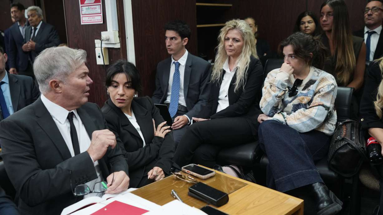Dalma Maradona, right, and Gianinna Maradona, second left, daughters of late soccer star Diego Maradona attend the first day of the trial over allegations of homicide by negligence against the medical team that treated their father in San Isidro, Argentina, Tuesday, April 14, 2026.