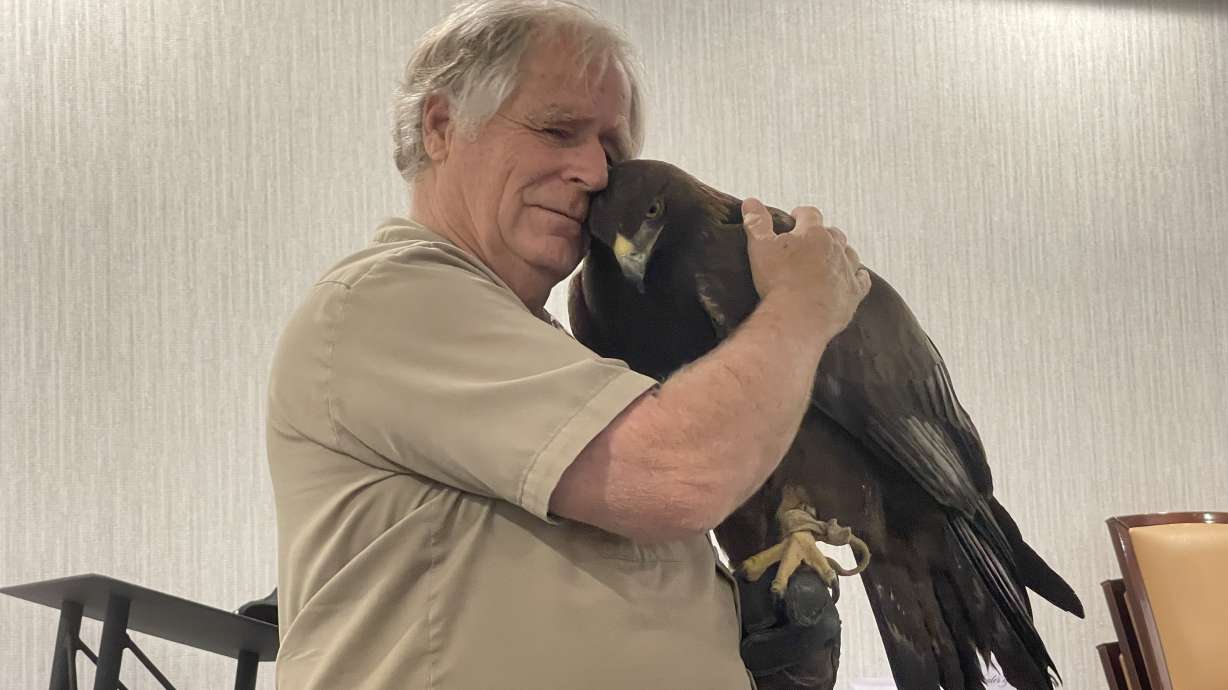 Martin Tyner, with his golden eagle, Scout, in Enoch. Tyner has spent his life rescuing and rehabilitating wild animals, forging friendships.