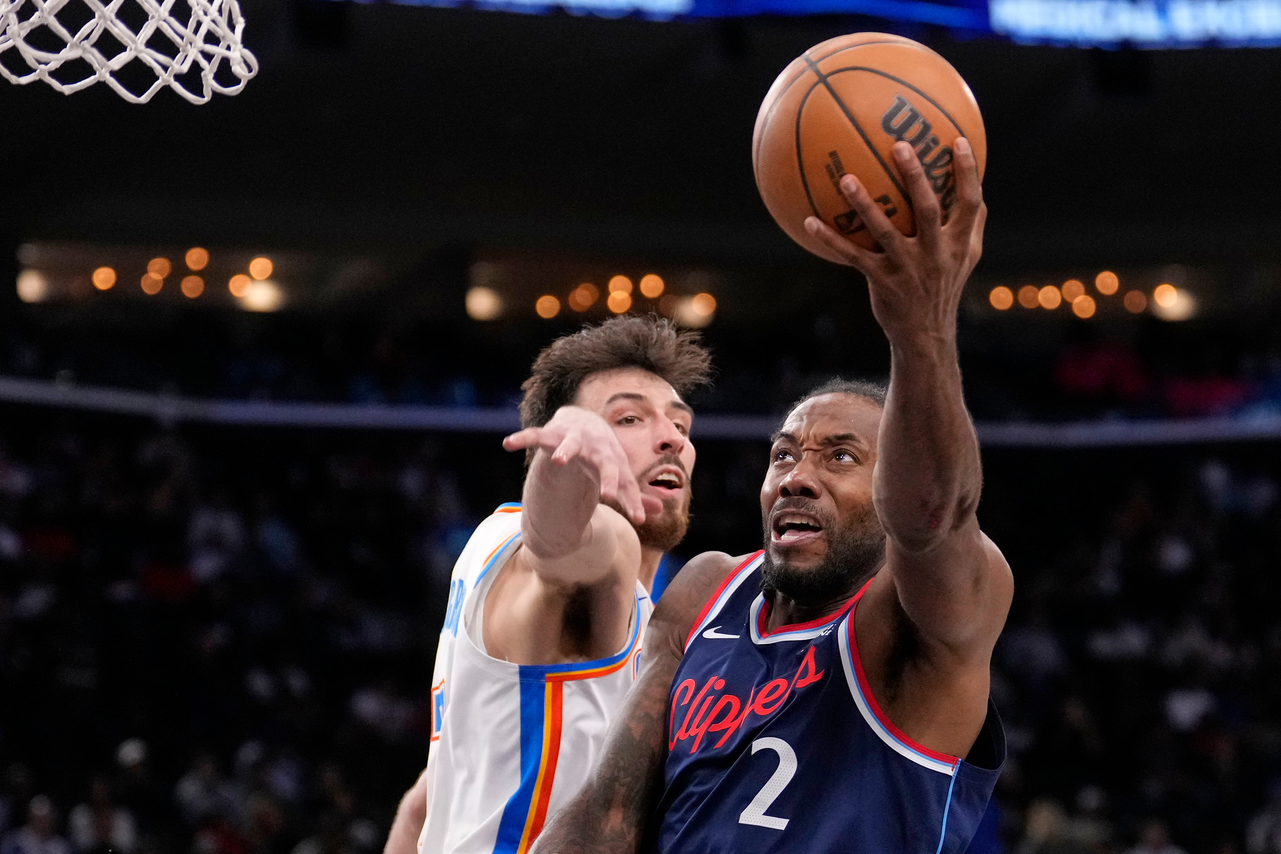 Los Angeles Clippers forward Kawhi Leonard, right, shoots as Oklahoma City Thunder center Chet Holmgren defends during the second half of an NBA basketball game Wednesday, April 8, 2026, in Inglewood, Calif. 