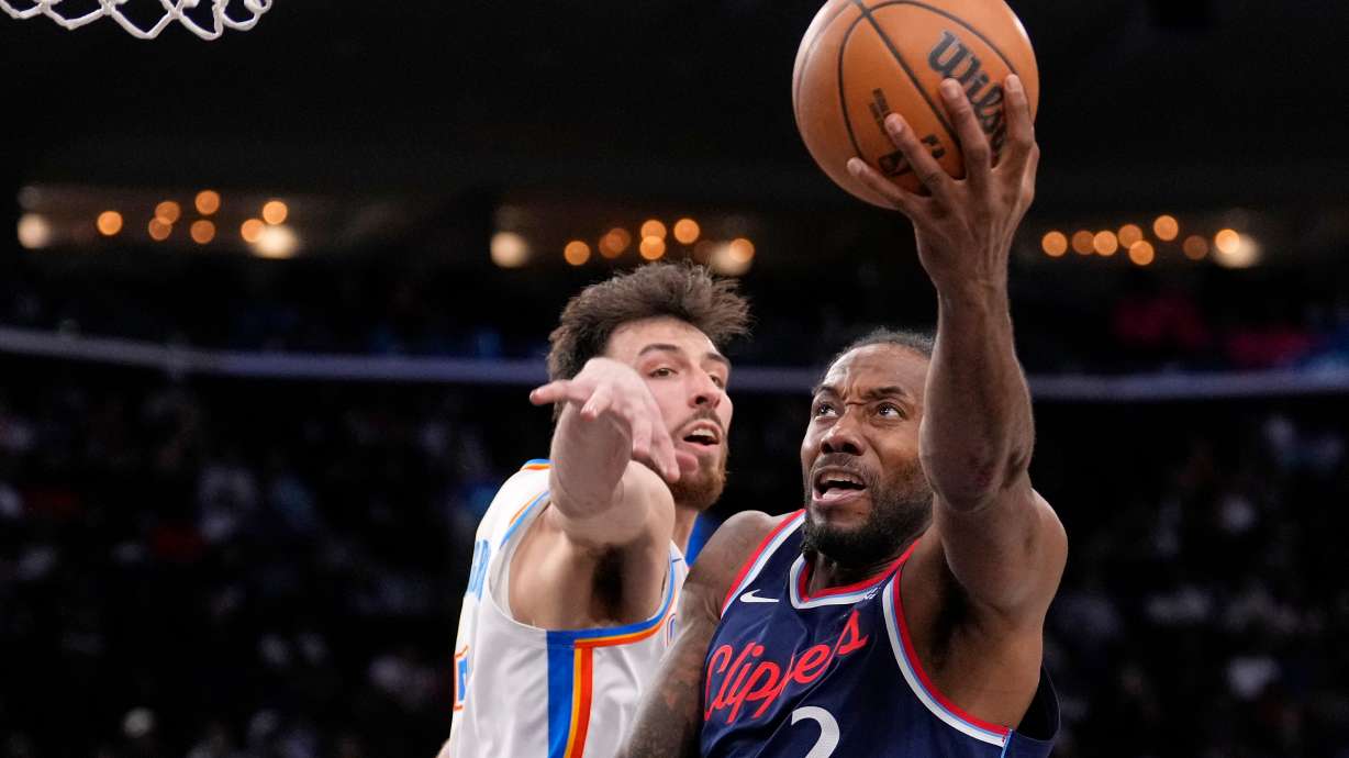 Los Angeles Clippers forward Kawhi Leonard, right, shoots as Oklahoma City Thunder center Chet Holmgren defends during the second half of an NBA basketball game Wednesday, April 8, 2026, in Inglewood, Calif.