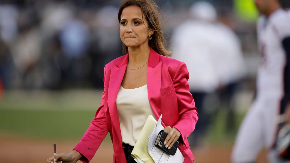 FILE- Reporter Dianna Russini works on the sidelines before the start of an NFL football game between the Oakland Raiders and the Denver Broncos Monday, Sept. 9, 2019, in Oakland, Calif.