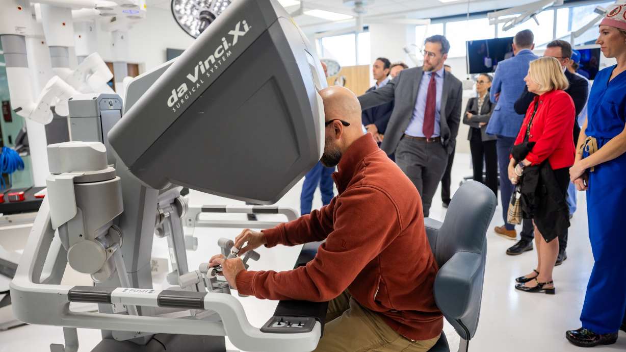Dustin Smith tests out the Da Vinci Robotic Surgical System inside the ASCENT Surgical Lab during a formal dedication event at the James Levoy Sorenson Center for Medical Innovation in Salt Lake City on Tuesday.