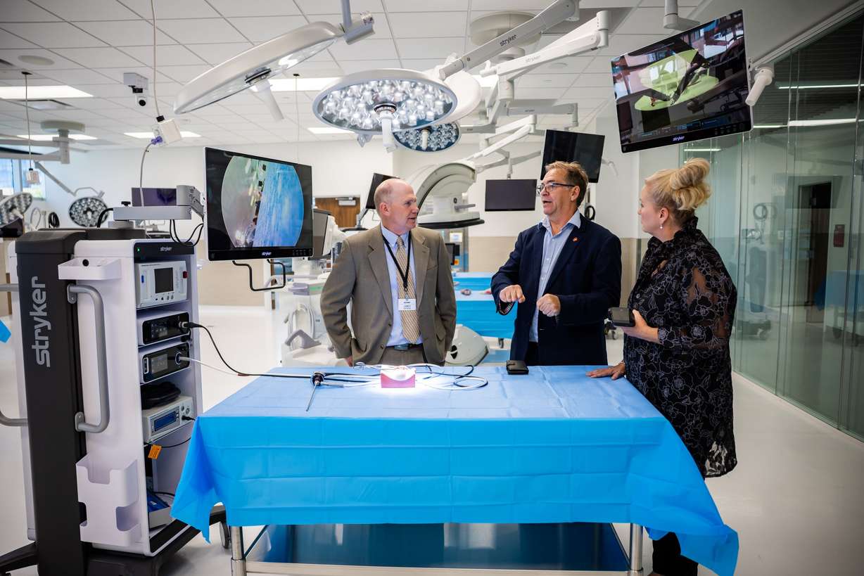 James Stock, Stryker OR designer, Mark Roe, CEO and co-founder of Fusetec, and Sandi Roe, content creator for Fusetec, from left, mingle in the ASCENT Surgical Lab during a formal dedication event at the James Levoy Sorenson Center for Medical Innovation in Salt Lake City on Tuesday. The nearly 60,000-square-foot, four-level center is designed to accelerate medical research, medical device development and life sciences training.