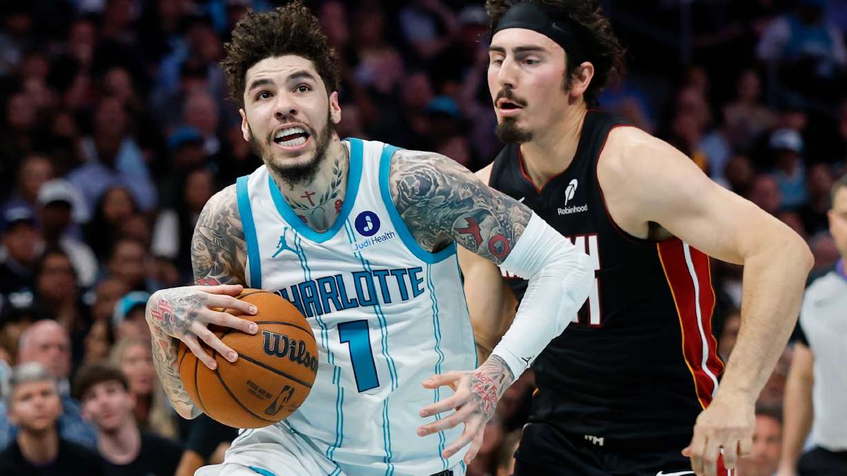 Charlotte Hornets guard LaMelo Ball (1) drives to the basket against Miami Heat forward Jaime Jaquez Jr. during the first half of an NBA play-in tournament basketball game in Charlotte, N.C., Tuesday, April 14, 2026.