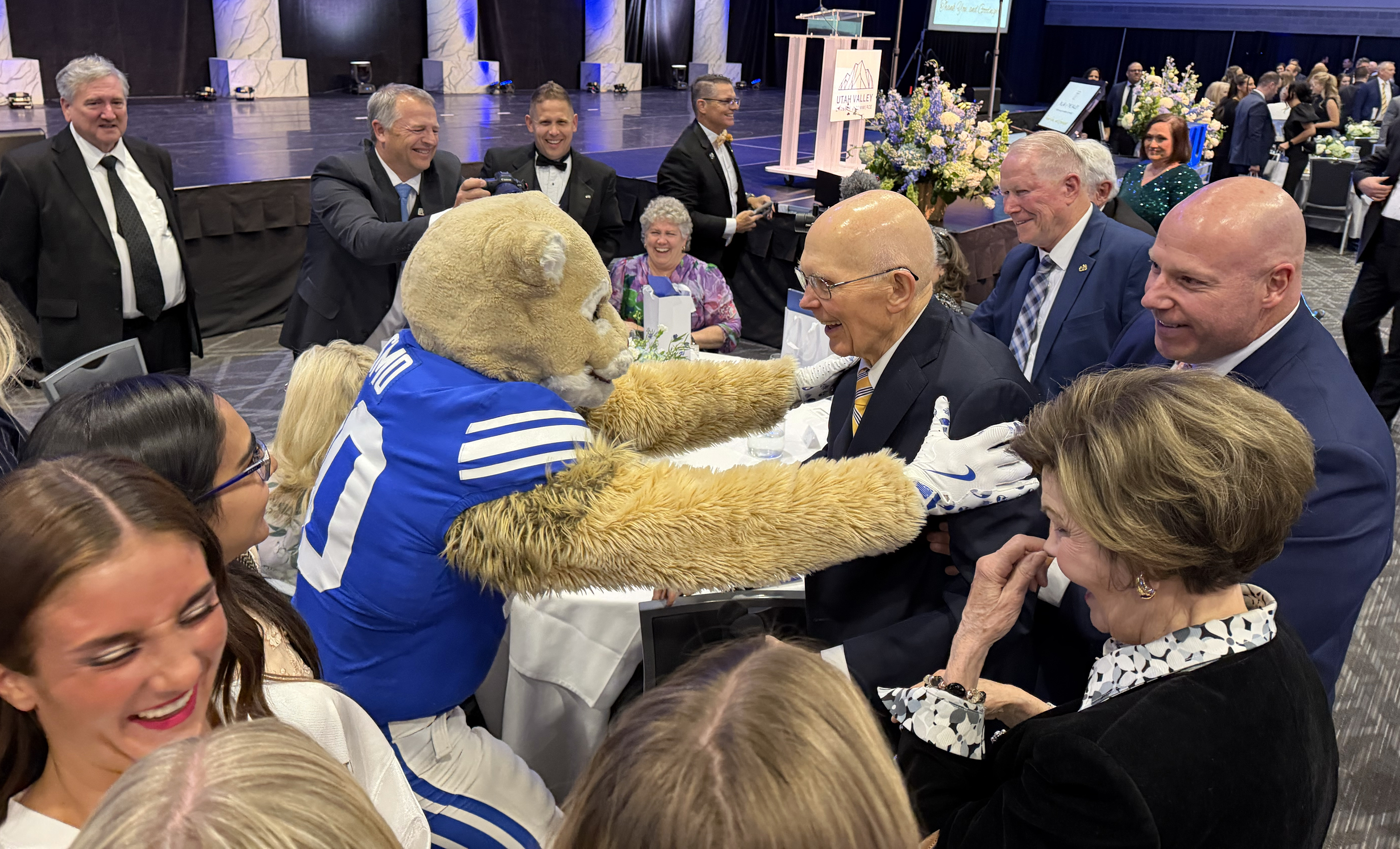 Cosmo the Cougar congratulates President Dallin H. Oaks of The Church of Jesus Christ of Latter-day Saints after the  Utah Valley Chamber’s Pillar of the Valley event where President Oaks was honored at the Utah Valley Convention Center in Provo, Ut.,  April 14, 2026.