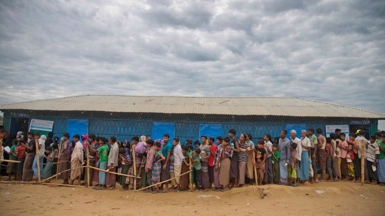 Rohingya Muslims, who crossed over from Myanmar into Bangladesh, wait in queues to receive aid at Kutupalong refugee camp in Ukhiya, Bangladesh, Nov. 15, 2017. At least 250 people are missing after a boat sank in the Andaman Sea.