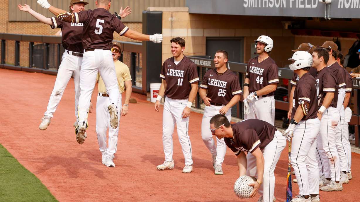 FILE - Lehigh catcher Owen Walewander (5) celebrates with his teammates after hitting a three-run home run against Saint Joseph's in the third inning during an NCAA college baseball game, March 31, 2026, in Philadelphia.