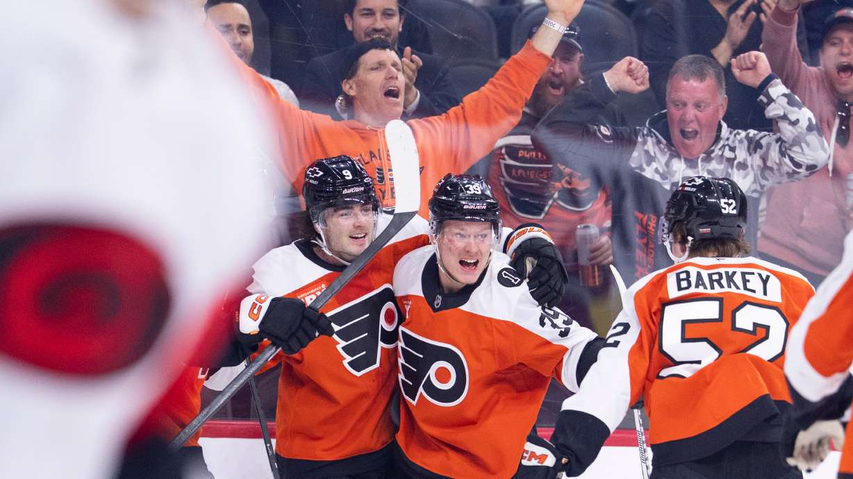 Philadelphia Flyers right winger Matvei Michkov, center, celebrates after his goal with defenseman Jamie Drysdale, left, and center Denver Barkey, right, during the second period of an NHL hockey game against the Carolina Hurricanes, Monday, April 13, 2026, in Philadelphia.