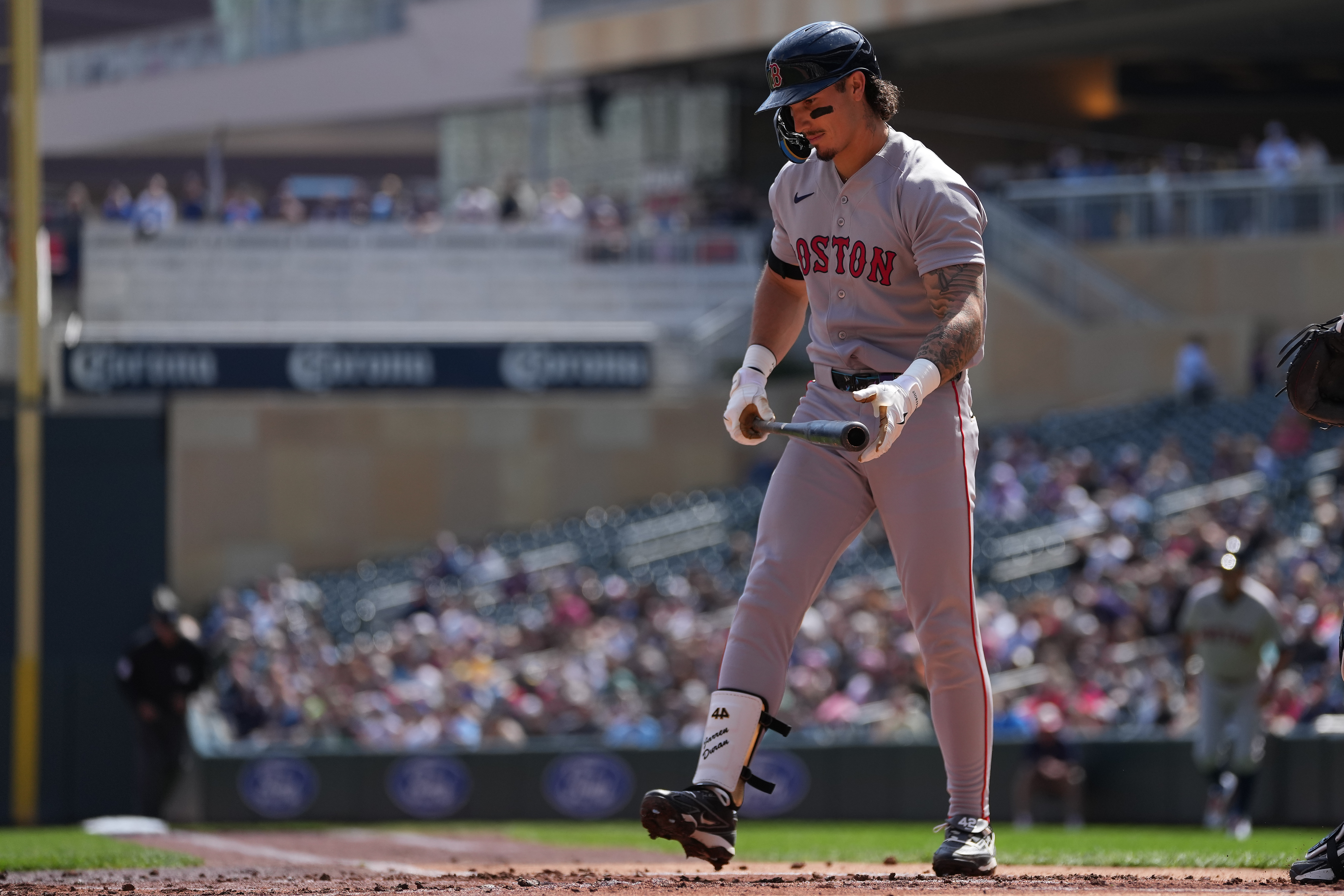 Boston Red Sox's Jarren Duran walks back to the dugout after striking out during the first inning of a baseball game against the Minnesota Twins Wednesday, April 15, 2026, in Minneapolis.