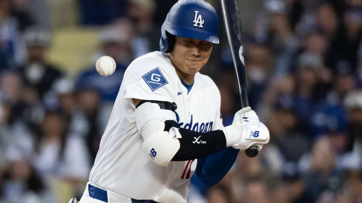 Los Angeles Dodgers' Shohei Ohtani is hit by a pitch during the first inning of a baseball game against the New York Mets in Los Angeles, Monday, April 13, 2026.