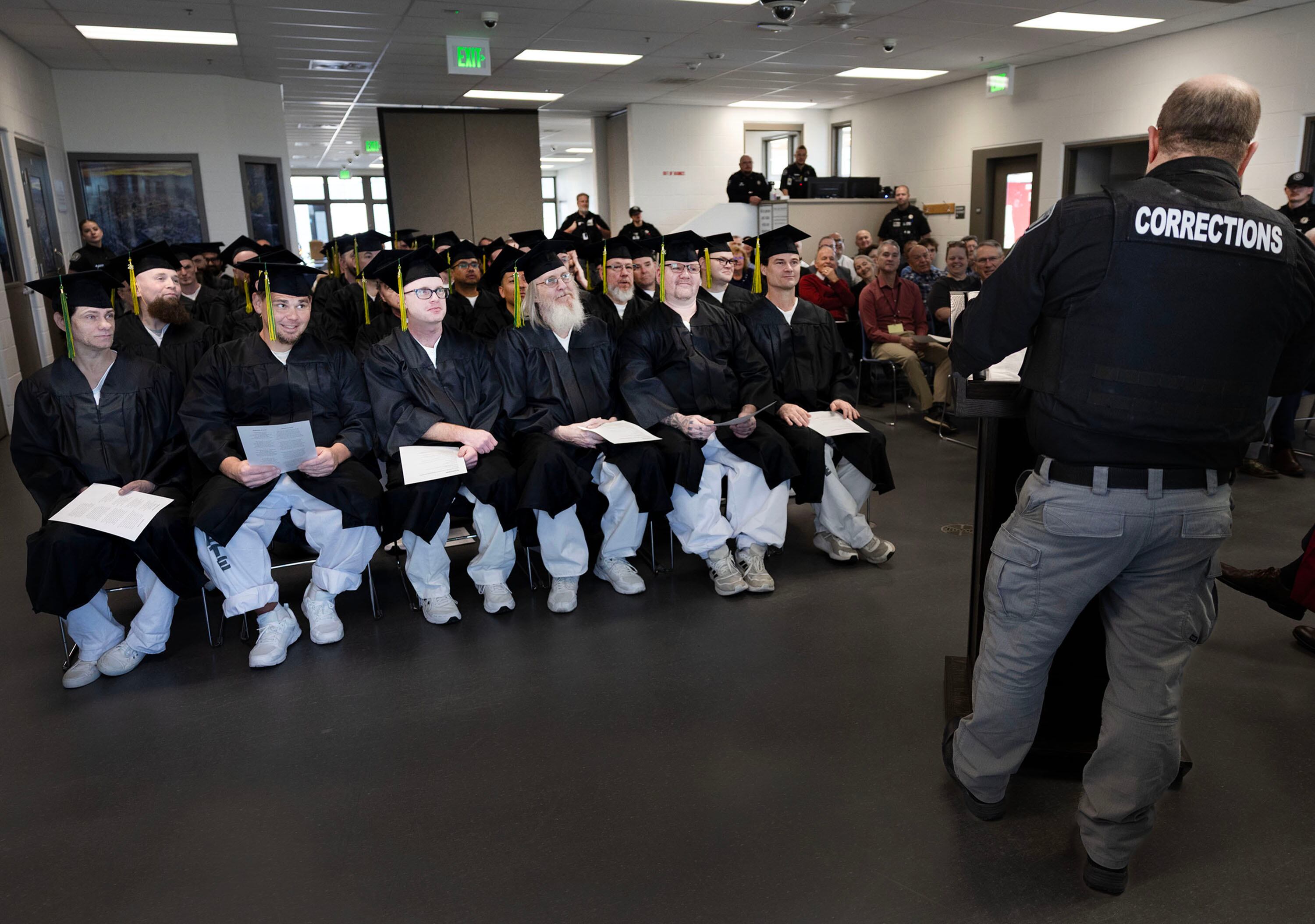 Ensign College Prison Education Program graduates listen to Sgt. Robert Lee during the graduation ceremony at the Utah State Correctional Facility in Salt Lake City on Wednesday. The ceremony was the first commencement held off-campus in the school's history.