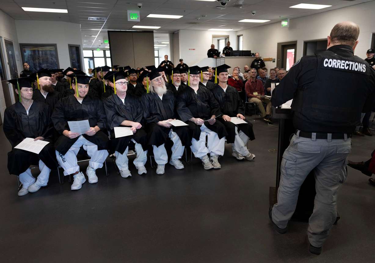 Ensign College Prison Education Program graduates listen to Sgt. Robert Lee during the graduation ceremony at the Utah State Correctional Facility in Salt Lake City on Wednesday. The ceremony was the first commencement held off-campus in the school's history.