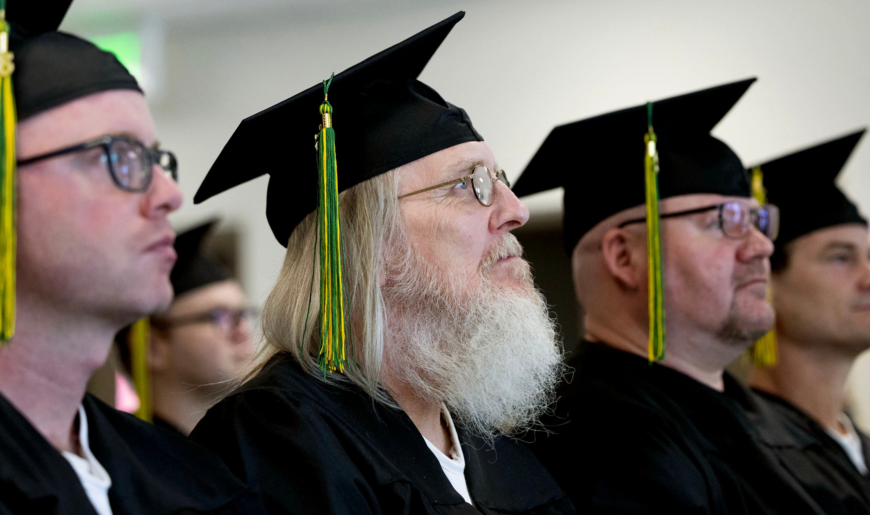 Graduates of the Ensign College Prison Education Program stand during their graduation ceremony at the Utah State Correctional Facility in Salt Lake City on Wednesday. The ceremony was the first held off-campus in the school's history.